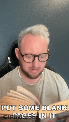 A Man Wearing Glasses Is Reading A Book With The Words Put Some Blank Pages In It GIF