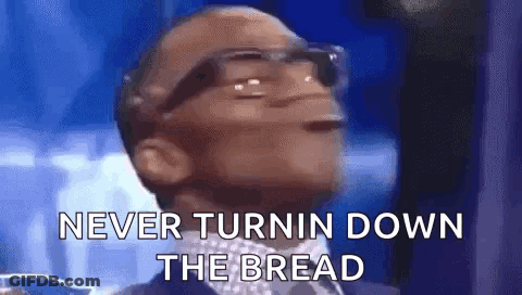 A Man Wearing Glasses Is Saying `` Never Turnin Down The Bread '' While Wearing A Suit And Tie . GIF