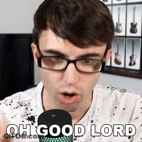 A Man Wearing Glasses Is Singing Into A Microphone With The Words Oh Good Lord Below Him GIF