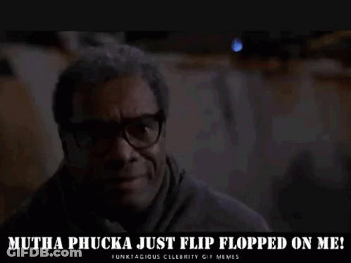 A Man Wearing Glasses Is Sitting In A Dark Room And Says `` Mutha Phucka Just Flip Flopped On Me '' . GIF