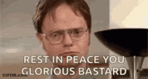 A Man Wearing Glasses Is Sitting In Front Of A Lamp And Says `` Rest In Peace You Glorious Bastard '' . GIF