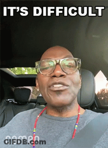 A Man Wearing Glasses Is Sitting In The Back Seat Of A Car With The Words It 'S Difficult Above Him GIF
