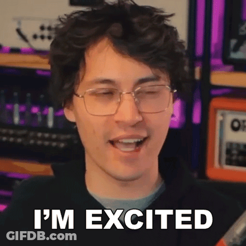 A Man Wearing Glasses Is Smiling And Saying I 'M Excited . GIF