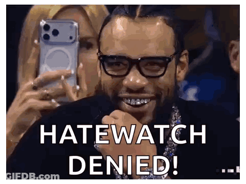 A Man Wearing Glasses Is Smiling While A Woman Takes A Picture Of Him With A Cell Phone . GIF