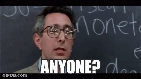 A Man Wearing Glasses Is Standing In Front Of A Blackboard And Saying `` Anyone ? '' . GIF
