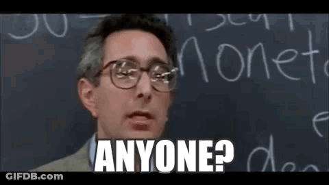 A Man Wearing Glasses Is Standing In Front Of A Blackboard And Says `` Anyone ? '' . GIF