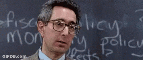 A Man Wearing Glasses Is Standing In Front Of A Blackboard That Says Bueller GIF