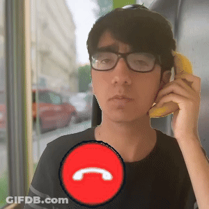 A Man Wearing Glasses Is Talking On A Phone With A Red Circle With The Letter C In It GIF