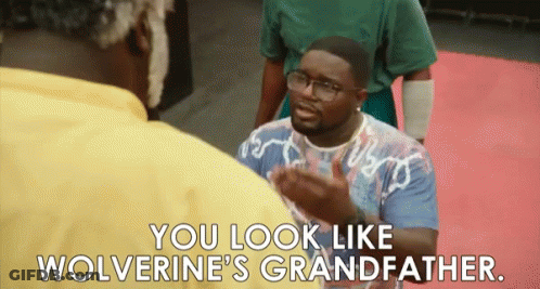 A Man Wearing Glasses Is Talking To Another Man And Says You Look Like Wolverine 'S Grandfather . GIF