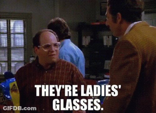 A Man Wearing Glasses Is Talking To Another Man In A Kitchen . GIF