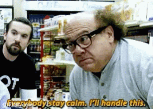 A Man Wearing Glasses Is Talking To Another Man In A Store While Another Man Watches . GIF