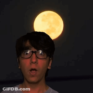 A Man Wearing Glasses Looks Up At The Full Moon GIF