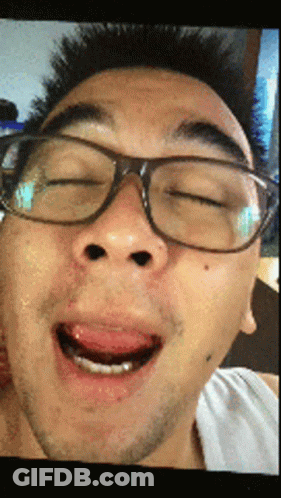 A Man Wearing Glasses Making A Funny Face With His Mouth Open GIF