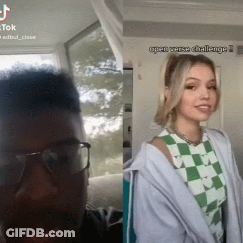 A Man Wearing Glasses Next To A Woman Wearing A Green And White Checkered Shirt .. GIF