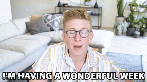 A Man Wearing Glasses Says I 'M Having A Wonderful Week In A Living Room GIF