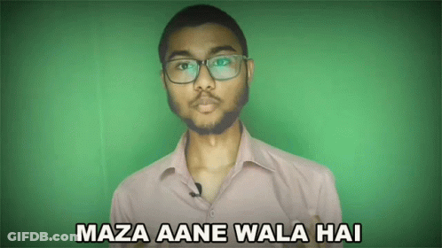 A Man Wearing Glasses Says Maza Aane Wala Hai On A Green Background GIF