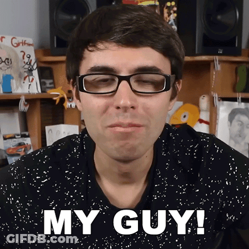 A Man Wearing Glasses Says " My Guy " In Front Of His Face GIF