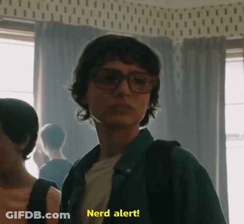 A Man Wearing Glasses Says Nerd Alert GIF