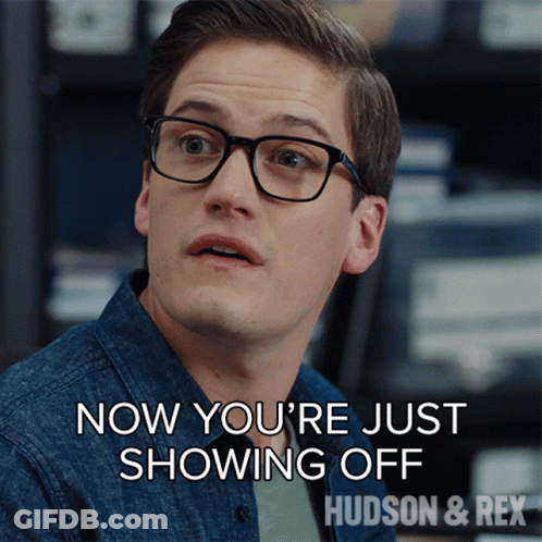 A Man Wearing Glasses Says " Now You 'Re Just Showing Off Hudson & Rex " GIF