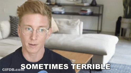 A Man Wearing Glasses Says " Sometimes Terrible " In Front Of A Couch GIF