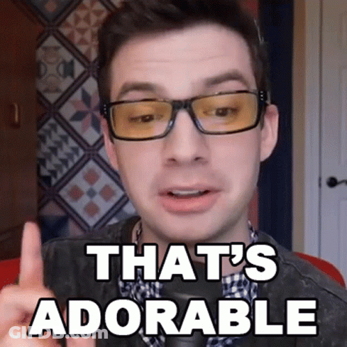 A Man Wearing Glasses Says That 'S Adorable With His Finger GIF