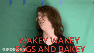 A Man Wearing Glasses Says Wakey Wakey Eggs And Bakey In Red Letters GIF