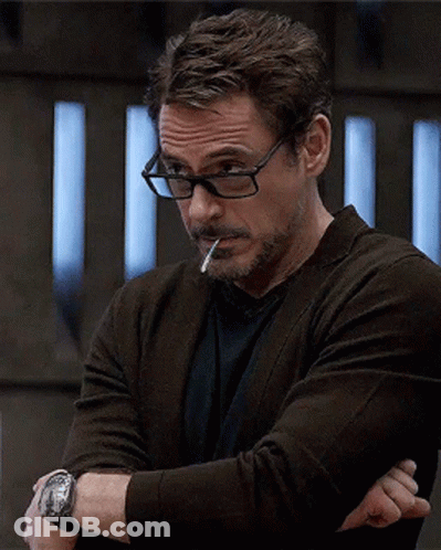 A Man Wearing Glasses Smoking A Cigarette And A Watch GIF