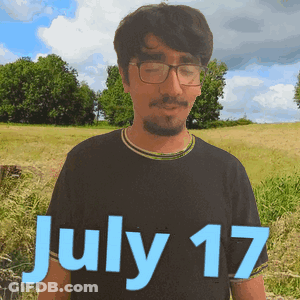 A Man Wearing Glasses Stands In A Field With The Date July 17 GIF