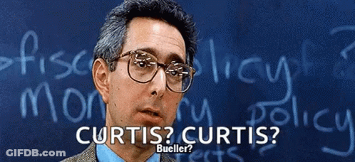 A Man Wearing Glasses Stands In Front Of A Chalkboard That Says Curtis Curtis Bueller GIF