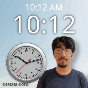 A Man Wearing Glasses Stands In Front Of A Clock That Says 10:12 Am GIF