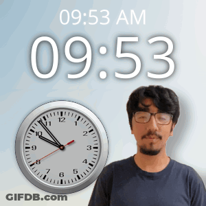 A Man Wearing Glasses Stands In Front Of A Clock That Says 10:53 Am GIF