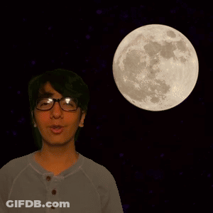 A Man Wearing Glasses Stands In Front Of A Full Moon In The Night Sky GIF