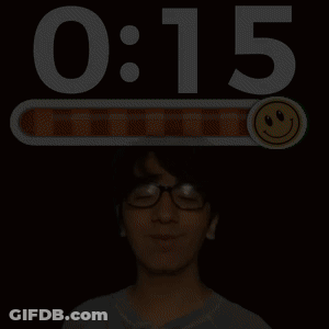 A Man Wearing Glasses Stands In Front Of A Screen That Says 0:06 And A Smiley Face GIF