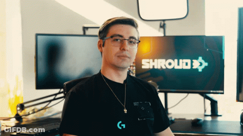 A Man Wearing Glasses Stands In Front Of A Screen That Says Shroud GIF