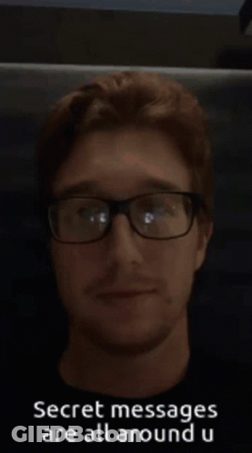 A Man Wearing Glasses With The Words Secret Messages Are All Around U On The Bottom GIF