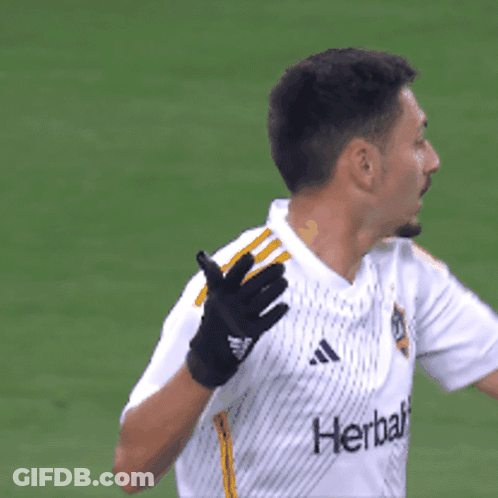 A Man Wearing Gloves And A Shirt That Says Herbalife GIF