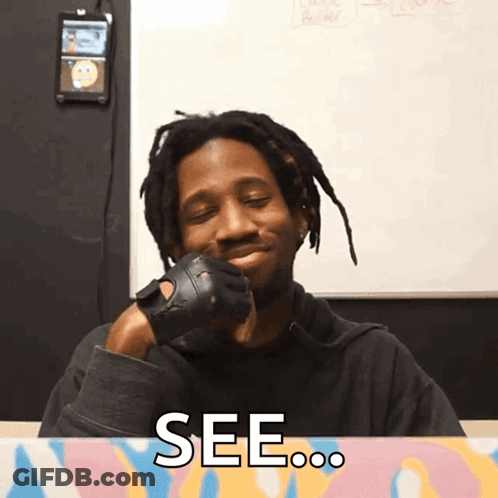 A Man Wearing Gloves Is Smiling And Says See On The Bottom GIF