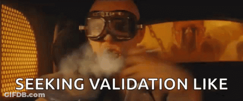 A Man Wearing Goggles Is Smoking A Cigarette And The Words `` Seeking Validation Like '' Are Visible In The Background . GIF