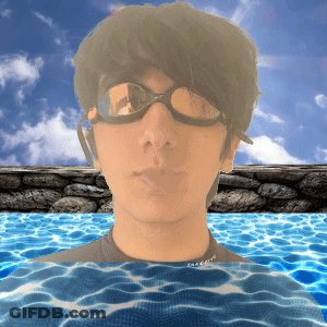 A Man Wearing Goggles Is Swimming In A Pool With The Word Face On His Shirt GIF