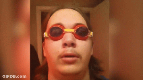 A Man Wearing Goggles With The Words It Is Wednesday On The Bottom GIF