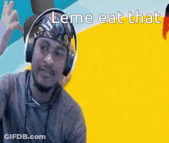 A Man Wearing Headphones And A Bandana Is Making A Funny Face . GIF