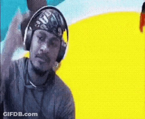 A Man Wearing Headphones And A Bandana On His Head Is Standing In Front Of A Yellow Background . GIF