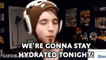 A Man Wearing Headphones And A Beanie Is Saying `` We 'Re Gonna Stay Hydrated Tonight ! '' GIF