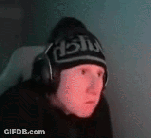 A Man Wearing Headphones And A Beanie Is Sitting In Front Of A Computer . GIF