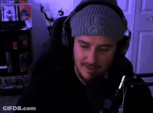 A Man Wearing Headphones And A Beanie Says " Ayy Man " In Red GIF