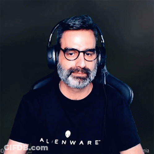 A Man Wearing Headphones And A Black Alienware Shirt GIF