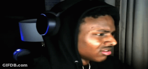 A Man Wearing Headphones And A Black Hoodie Looks To The Side GIF