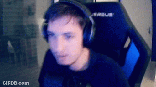 A Man Wearing Headphones And A Black Shirt Is Sitting In A Gaming Chair . GIF