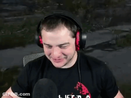 A Man Wearing Headphones And A Black Shirt Is Talking Into A Microphone . GIF