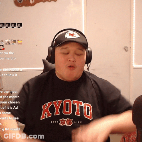 A Man Wearing Headphones And A Black Shirt That Says Kyoto On It GIF